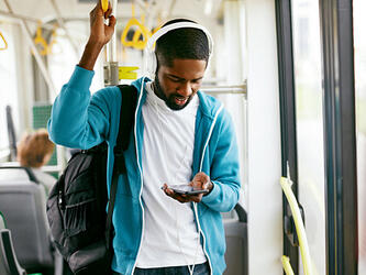 Passenger listening radio headphones bus oct26_crop
